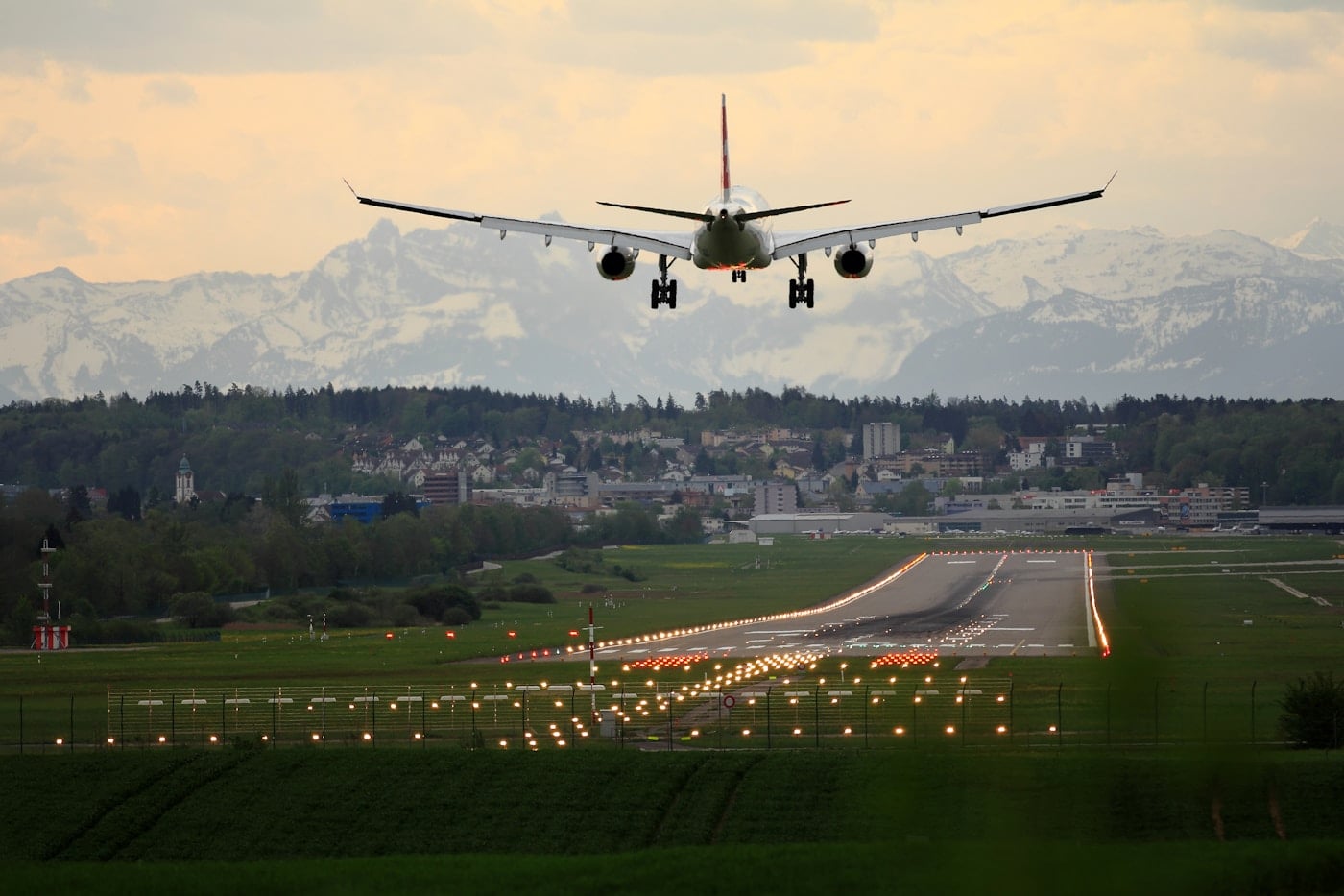 Airplane flying above an airport runway