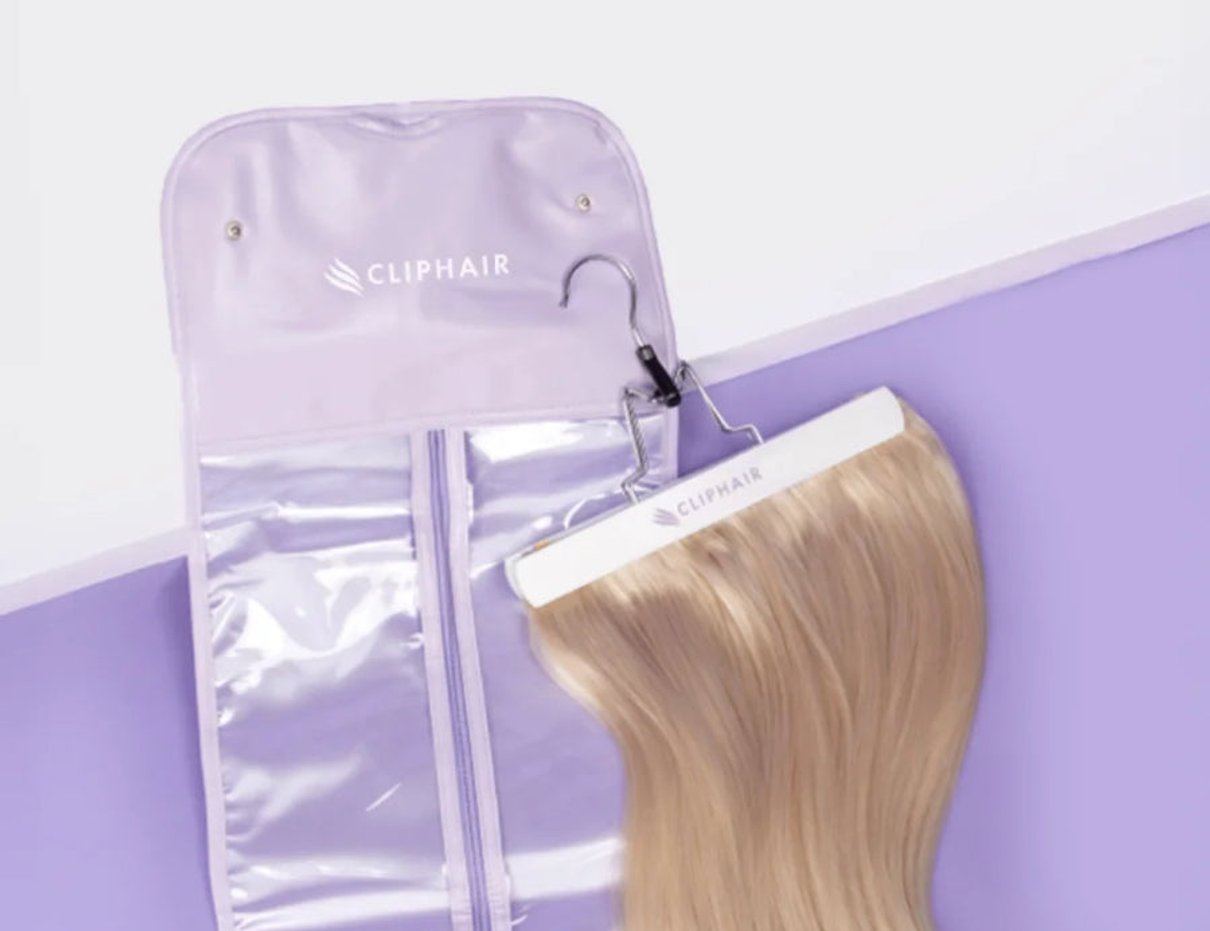 Cliphair hair extension hanger and carrier opened with hair extension