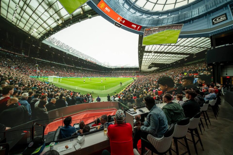 Fans watching a Premier League match inside Cosm's immersive Dome