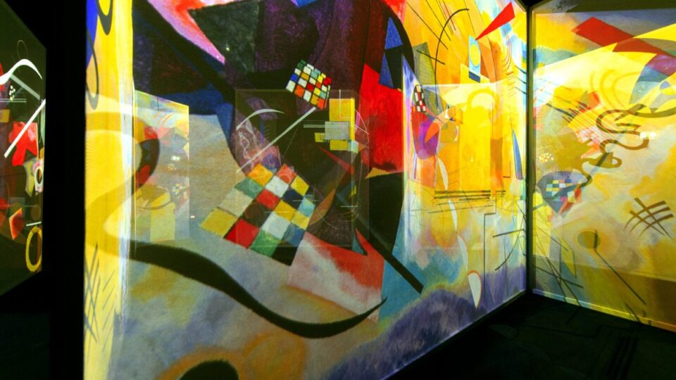 Visitors surrounded by colourful Kandinsky projections in a Frameless gallery