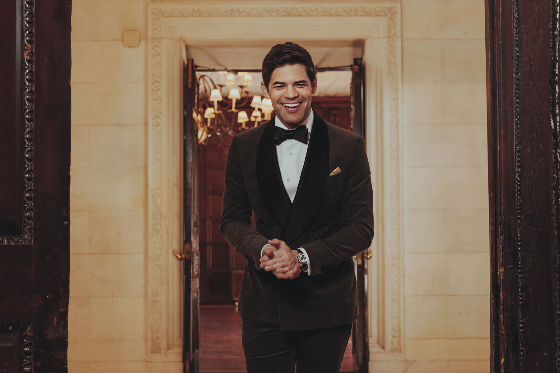 Man in a tuxedo standing in a doorway on The Great Gatsby stage