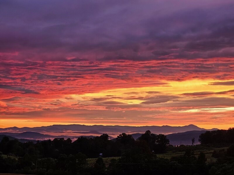 Colorful sunset over mountains at a host location
