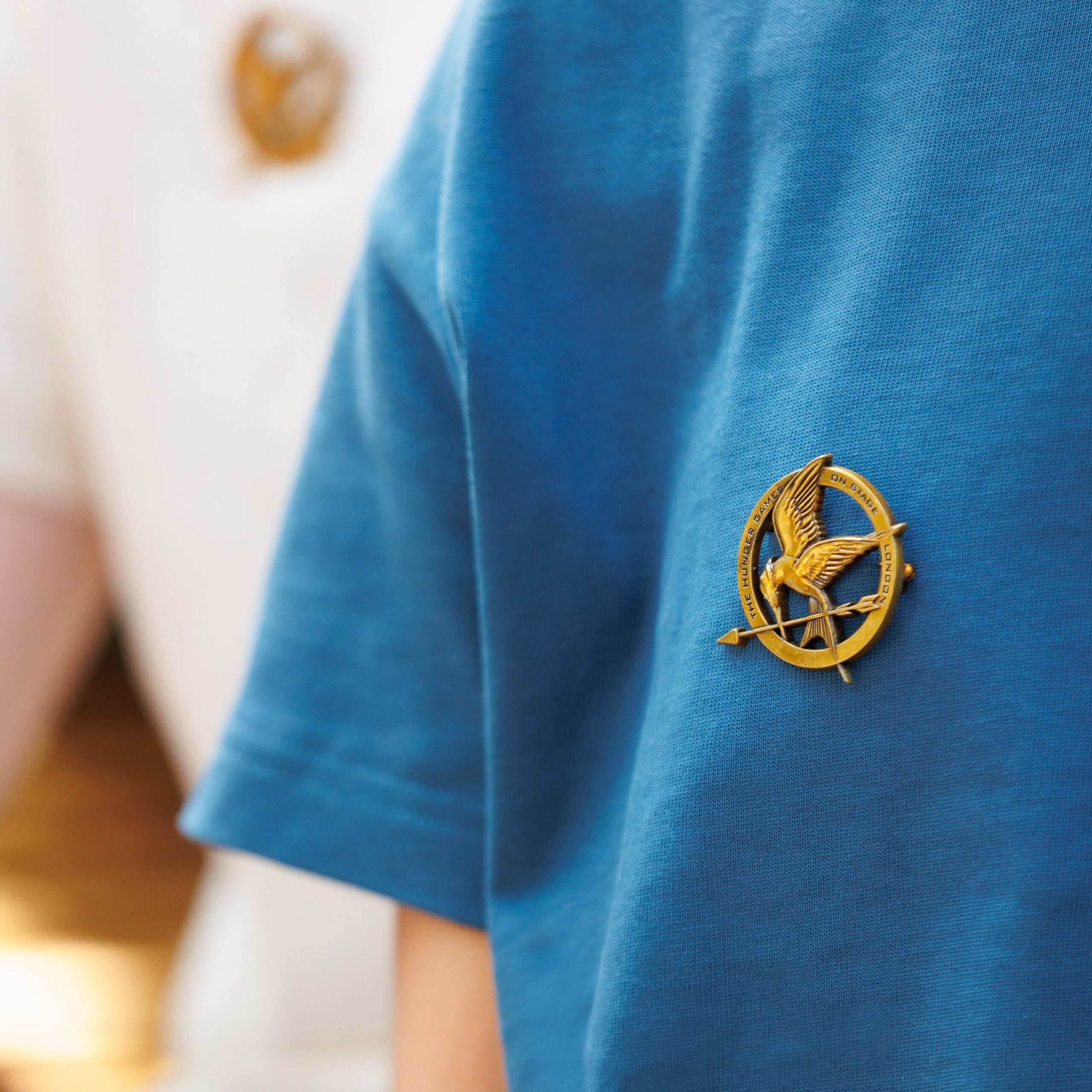 Mockingjay pin badge from The Hunger Games On Stage official shop