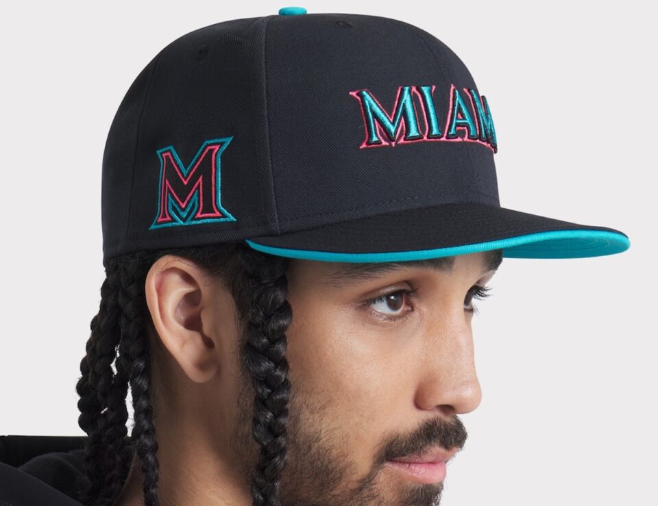 Person wearing a black Miami Marlins City Connect performance cap