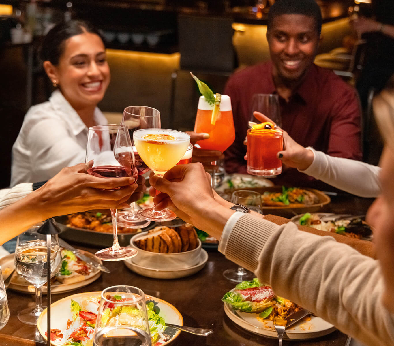 Friends dining with cocktails at ONE Dine