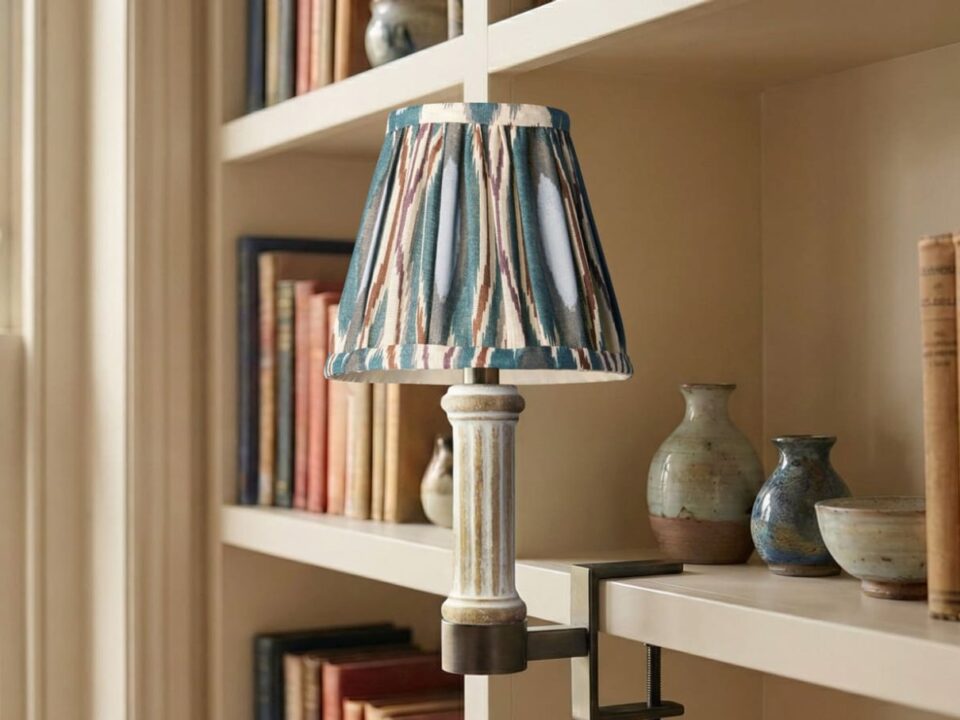 Pooky Bronte cordless bookshelf light styled with a patterned shade on a shelf