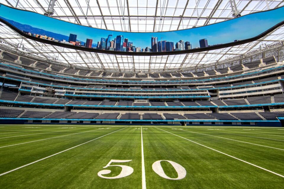 SoFi Stadium football field and oval video board beneath the translucent roof