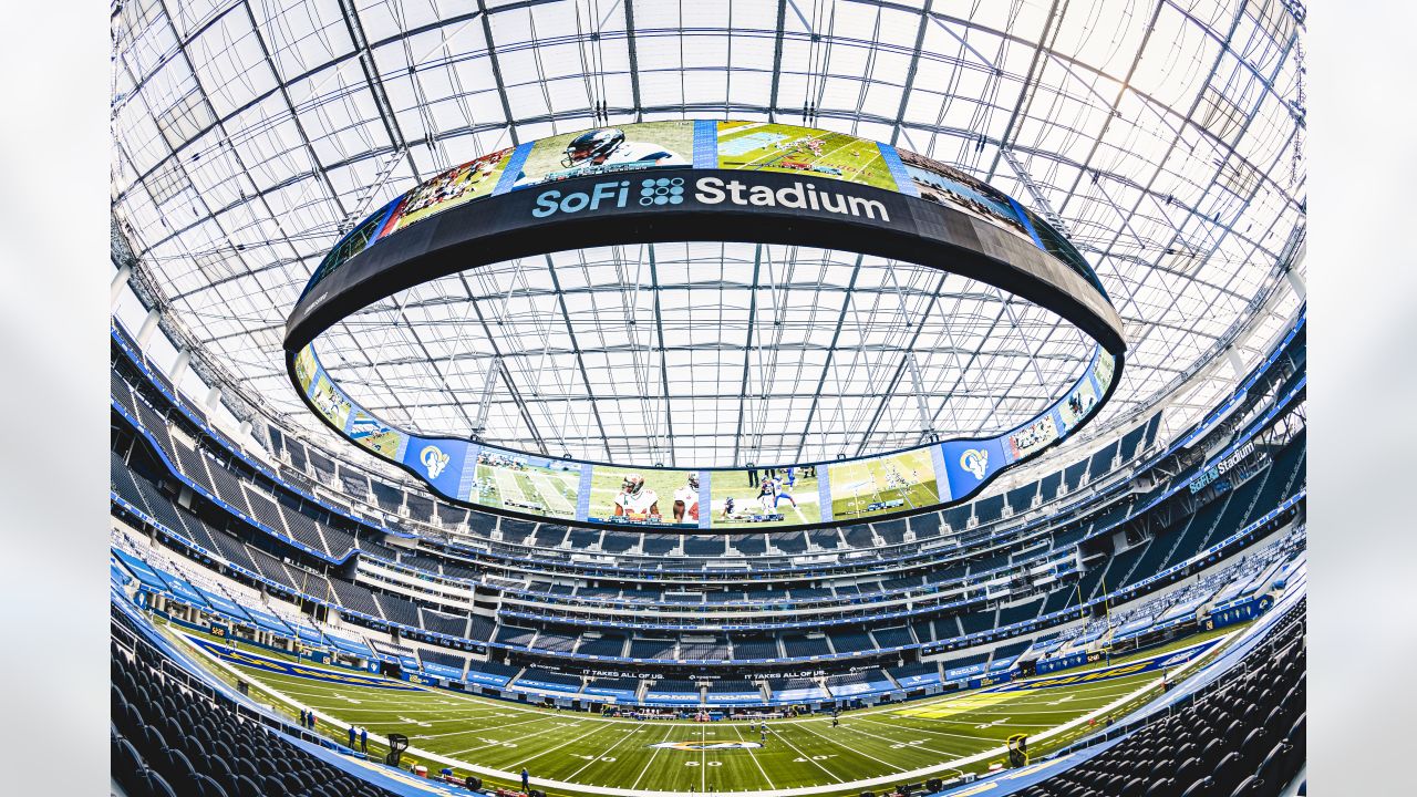 Empty SoFi Stadium football field with seating and video board