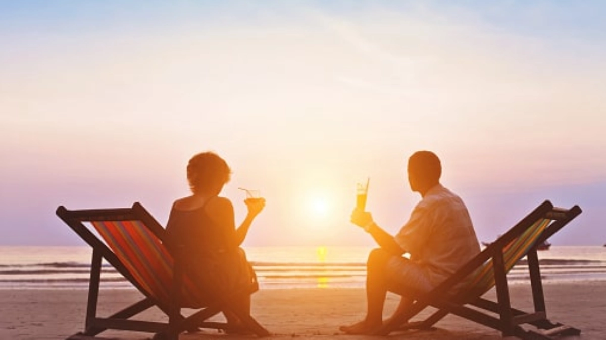 Couple relaxing on deckchairs at a beach