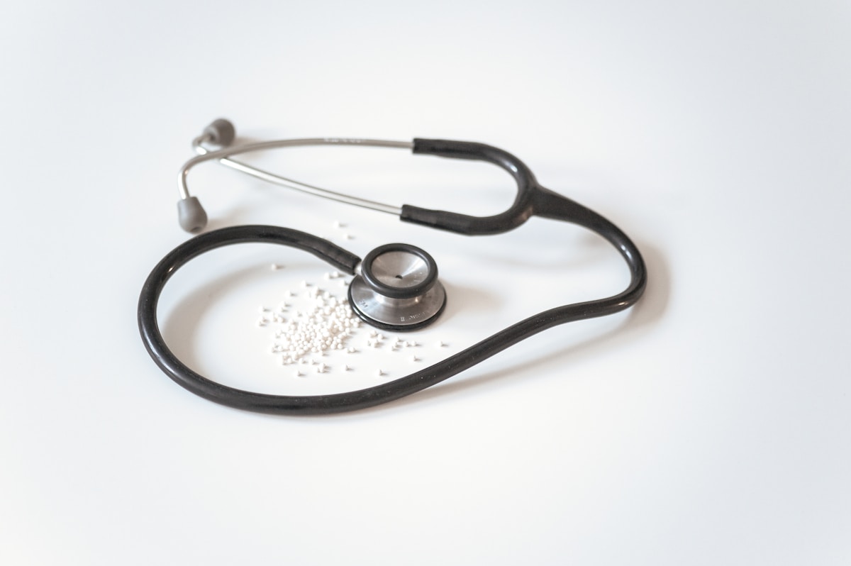 Stethoscope and pills arranged as medical supplies