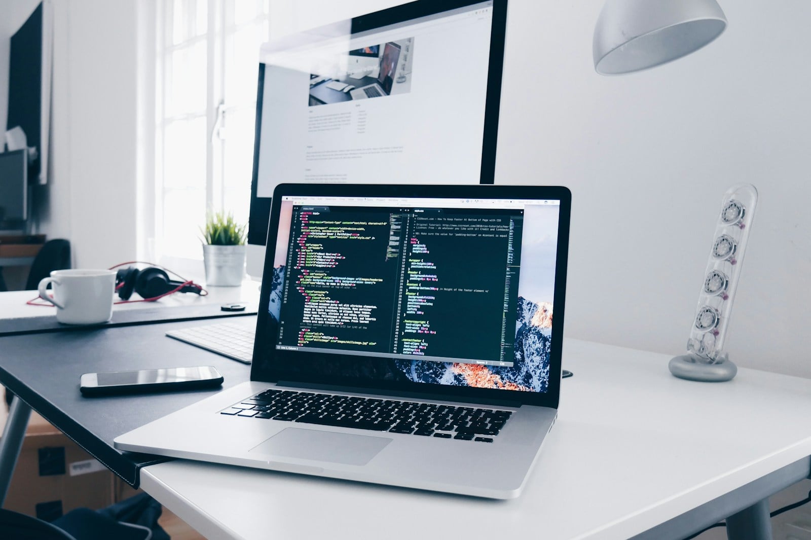 Laptop and code on a modern office desk