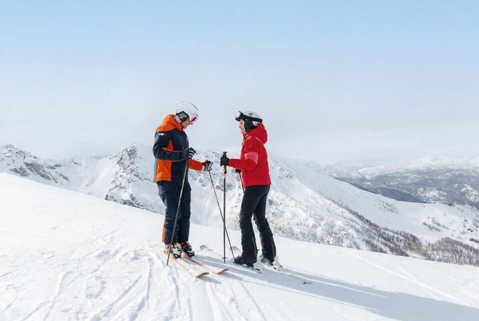 Skiers on a snowy Alpine slope at a Club Med resort