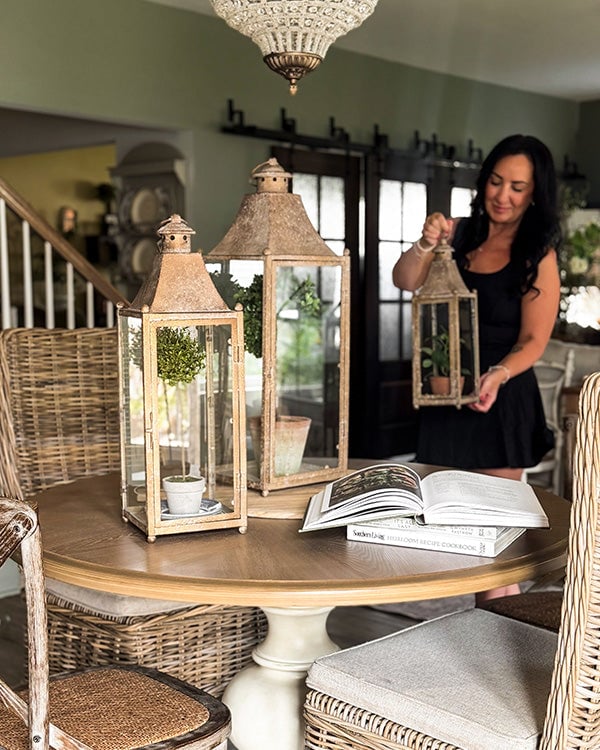 Set of three tiered metal and glass candle lanterns