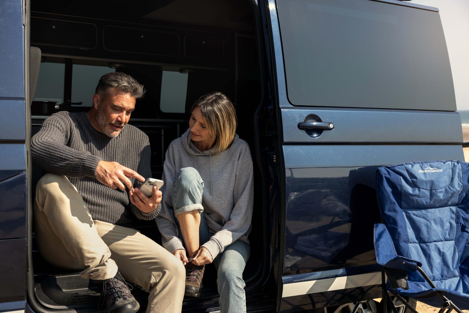 Couple seated inside a campervan during a DFDS road trip