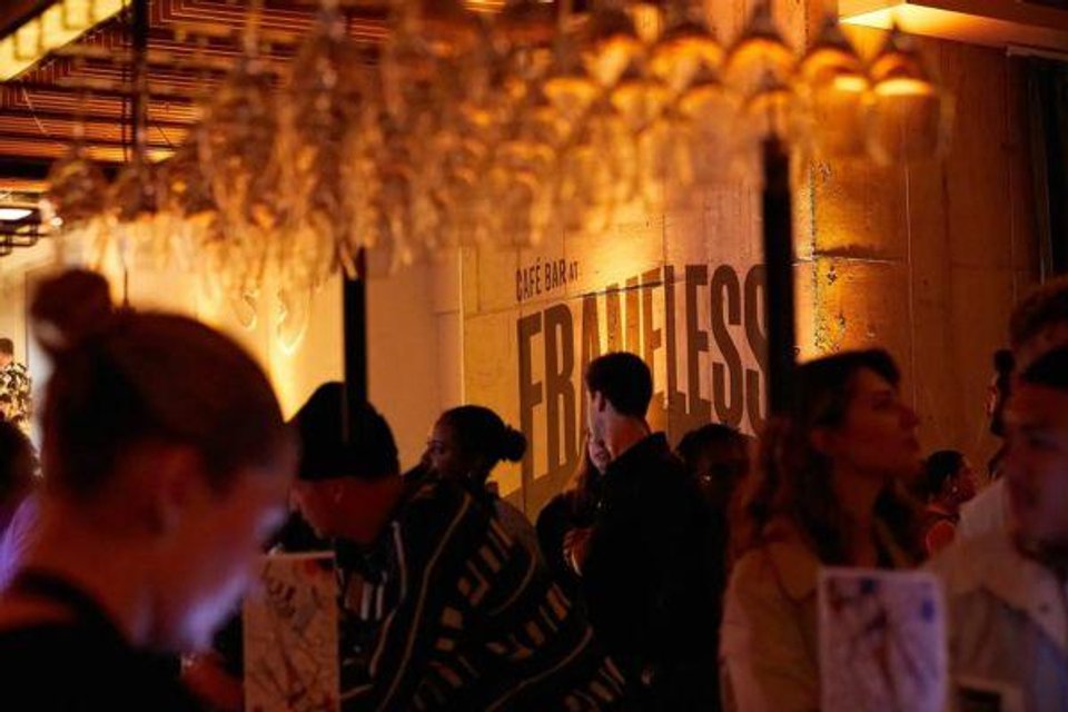 Crowded evening bar scene at Frameless Lates