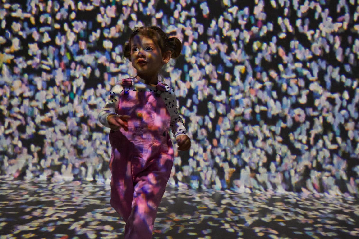 A child running through the immersive art galleries at Frameless