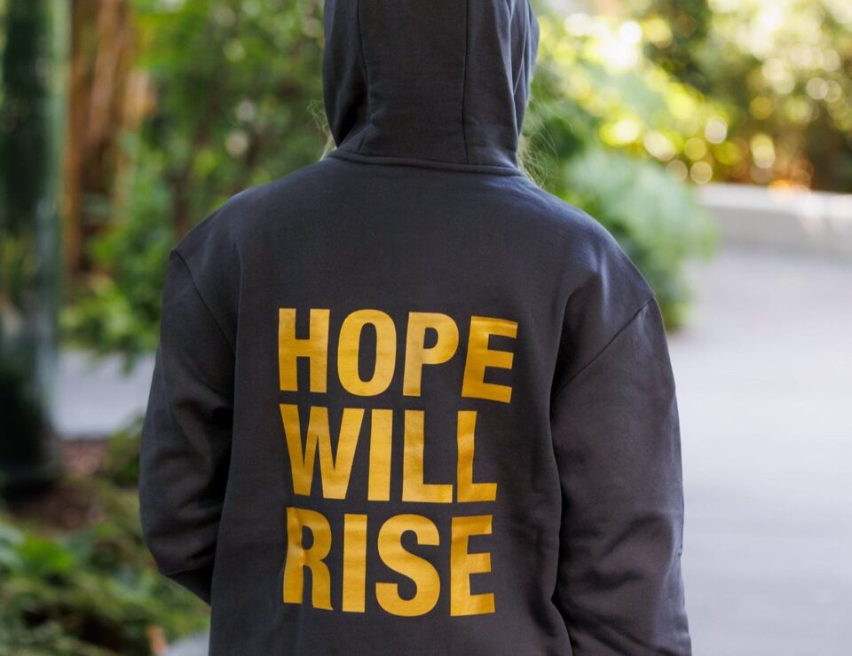 Hope Will Rise hoodie from Hunger Games on Stage styled in a lifestyle scene
