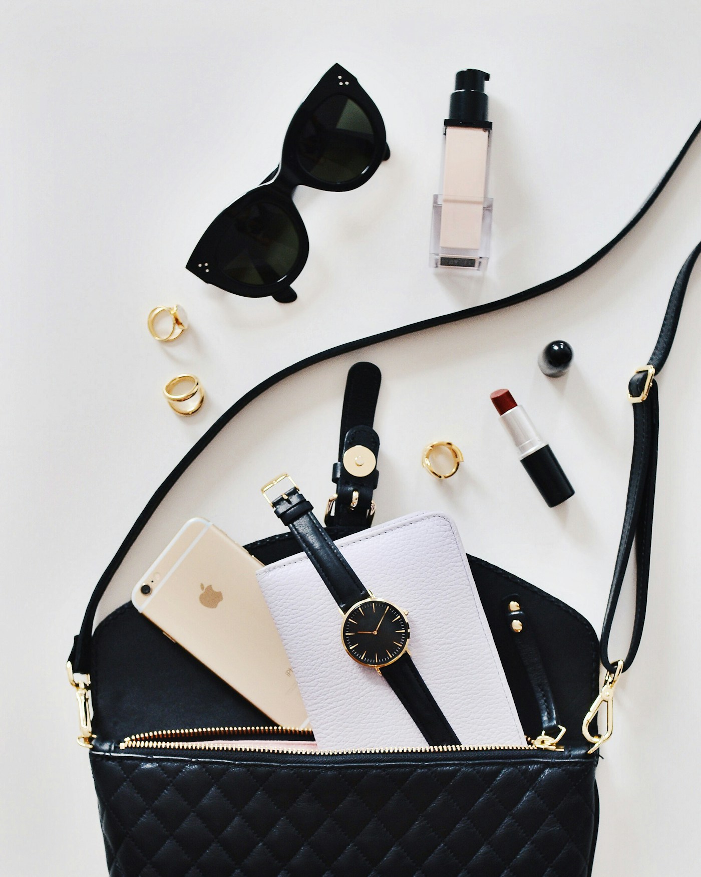 Curated fashion accessories arranged on a neutral surface