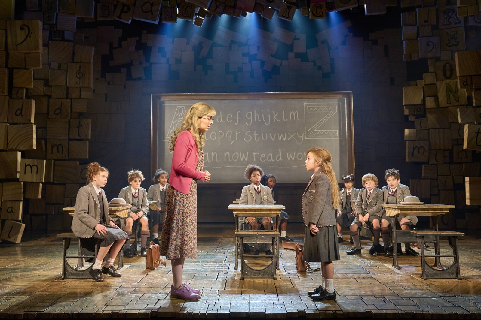 London cast performing Matilda The Musical in a colourful stage scene