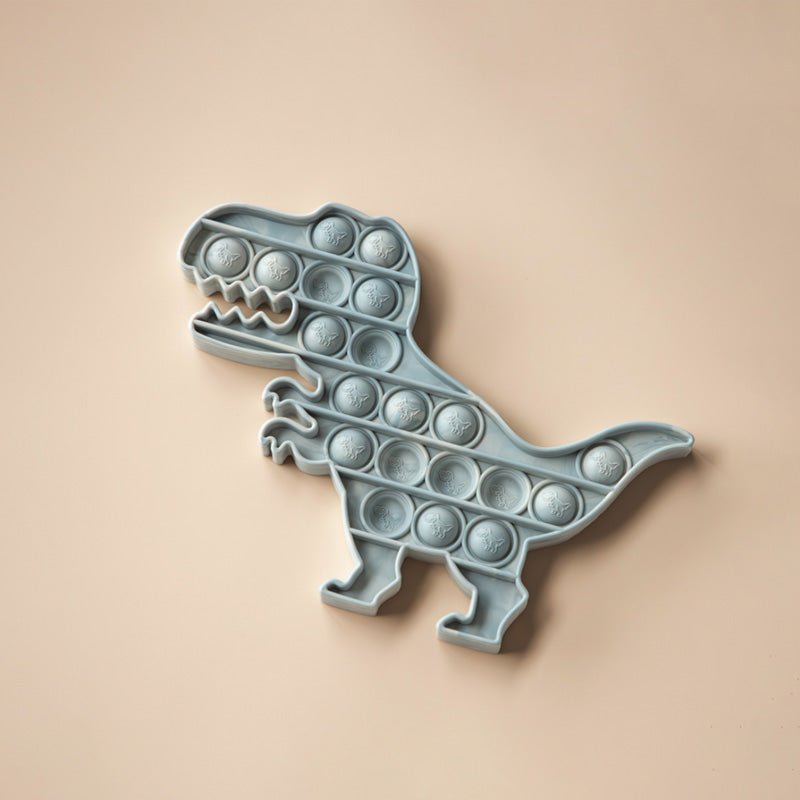 Moonkie Sensory Pop Toy shaped like a dinosaur