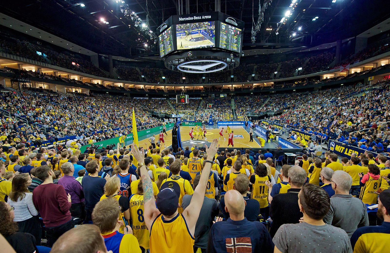 Basketball players competing on court