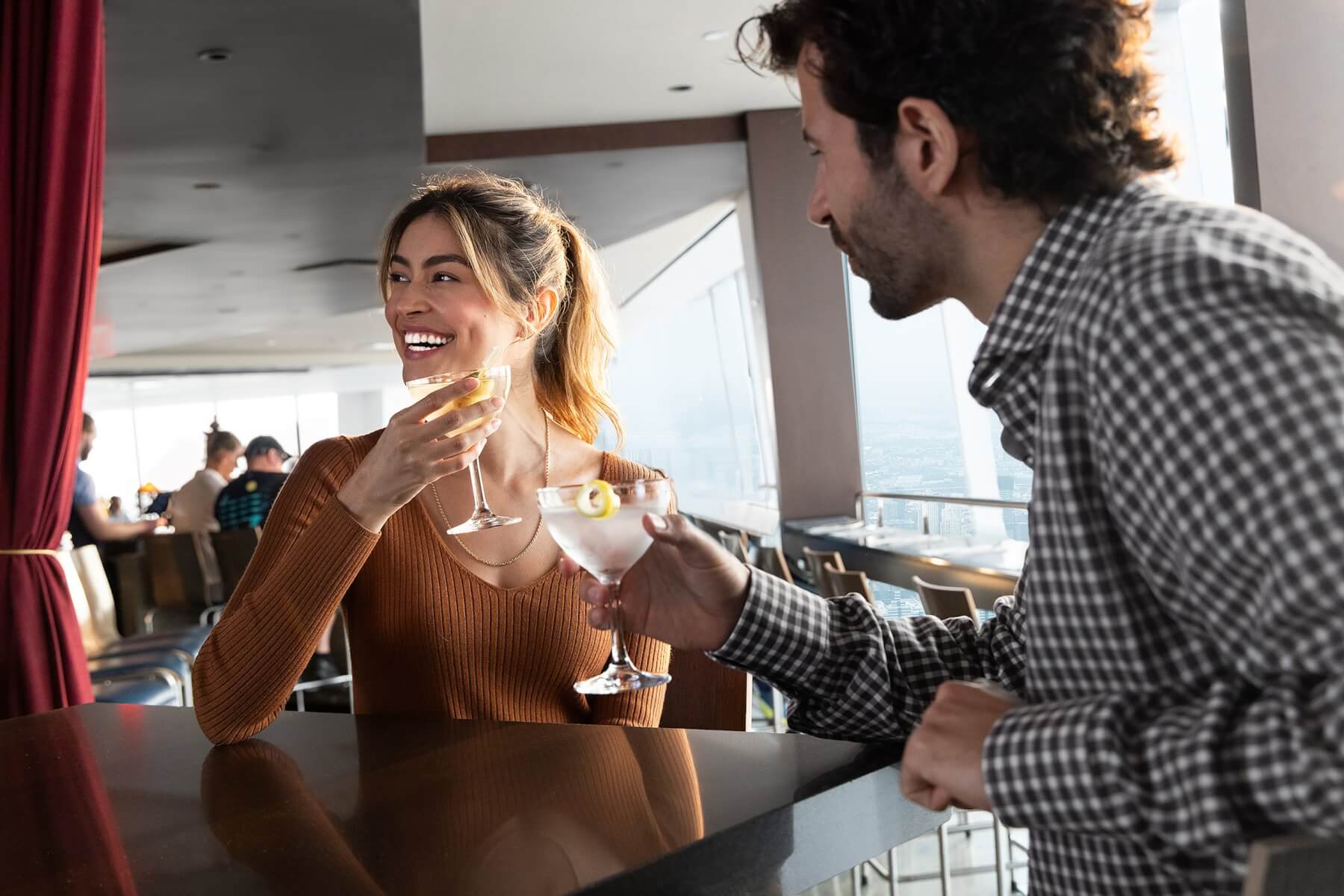 Couple dining with a daytime Manhattan view at ONE Dine