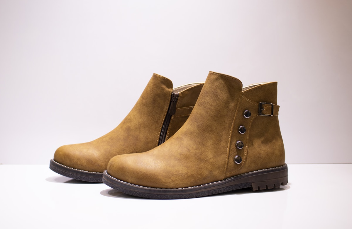 Tan ankle boots arranged on a floor