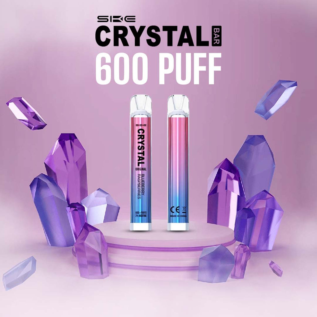 Two SKE Crystal Bar 600 disposable vapes on a styled purple display