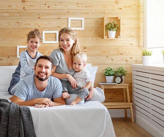 Family sitting on a Sleep EZ latex mattress