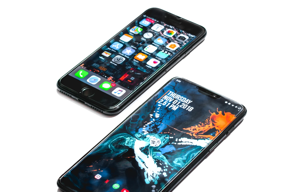 Two smartphones on a white surface
