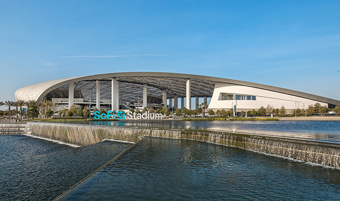 SoFi Stadium exterior with curved canopy and reflecting pool