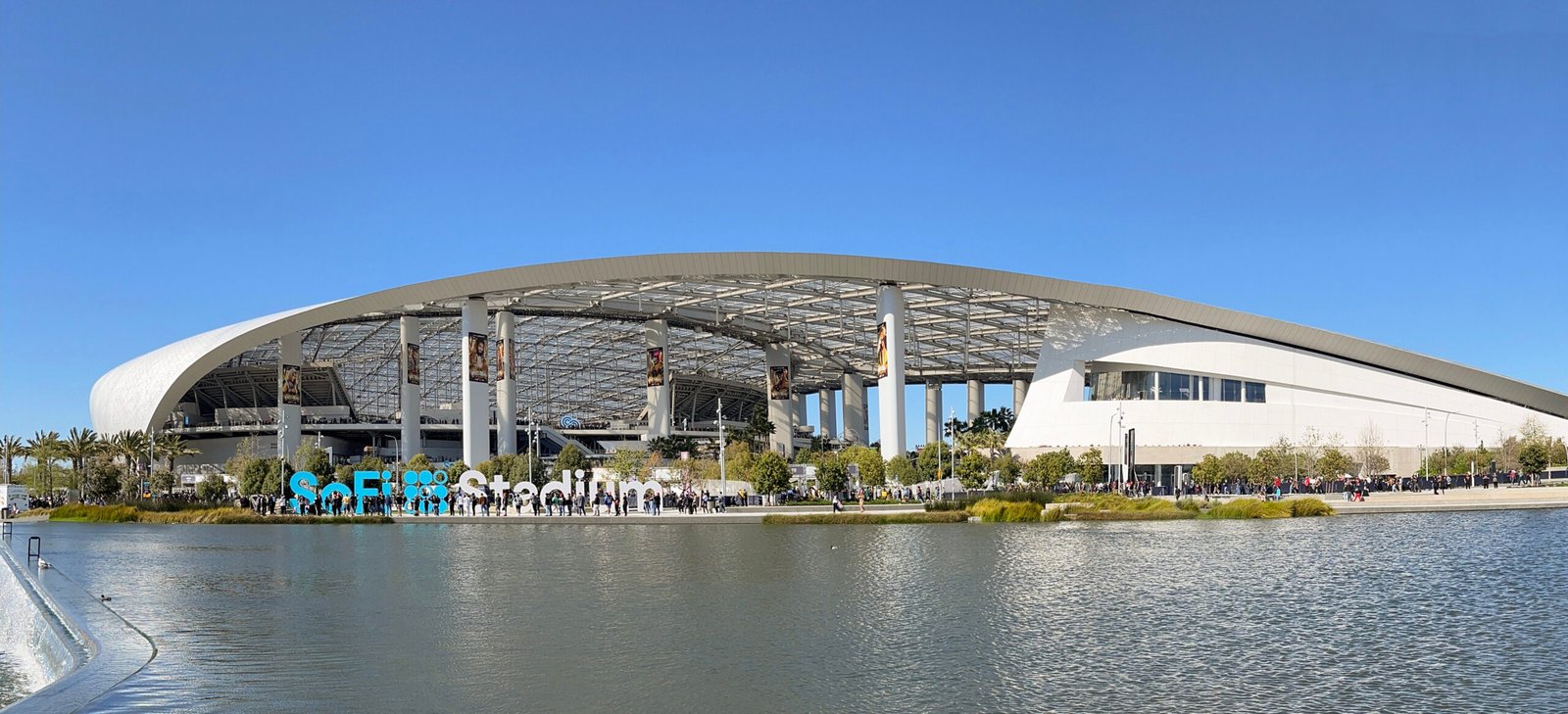 SoFi Stadium beside the landscaped lake and promenade