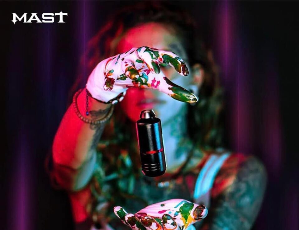 Tattoo artist holding a rotary pen machine