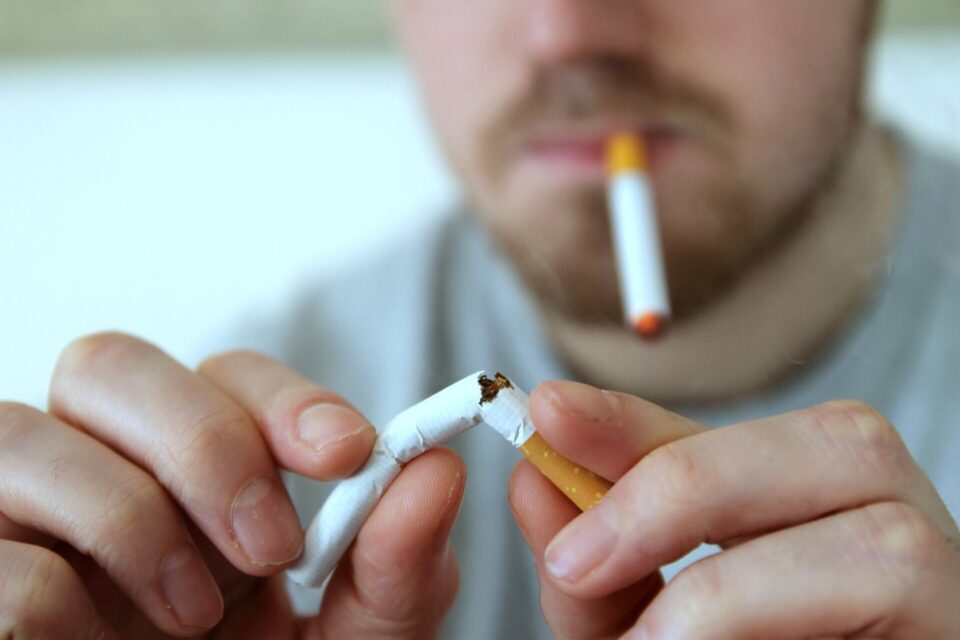 Person breaking a conventional cigarette