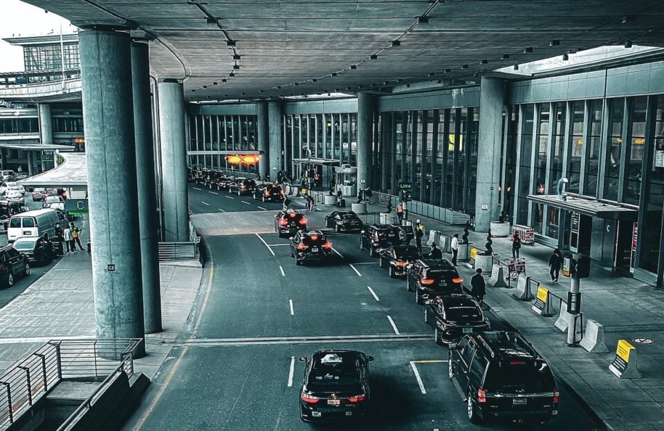 Vehicles at a covered airport terminal drop-off