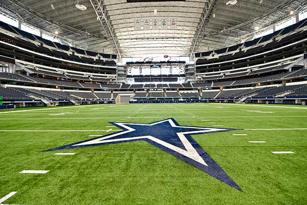 Dallas Cowboys star at midfield inside AT&T Stadium