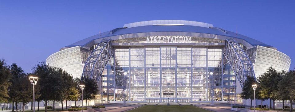AT&T Stadium exterior illuminated at dusk
