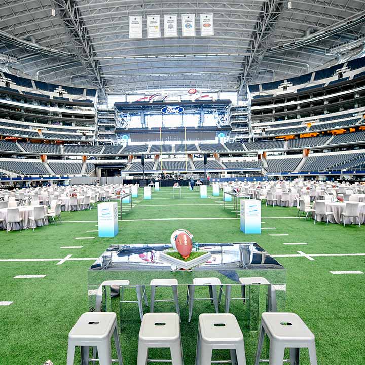 Field event setup with tables and seating inside AT&T Stadium