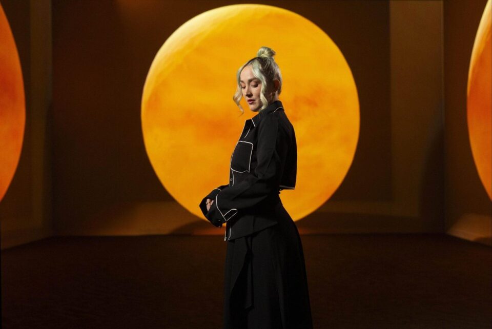 Visitors moving through an immersive Frameless gallery space