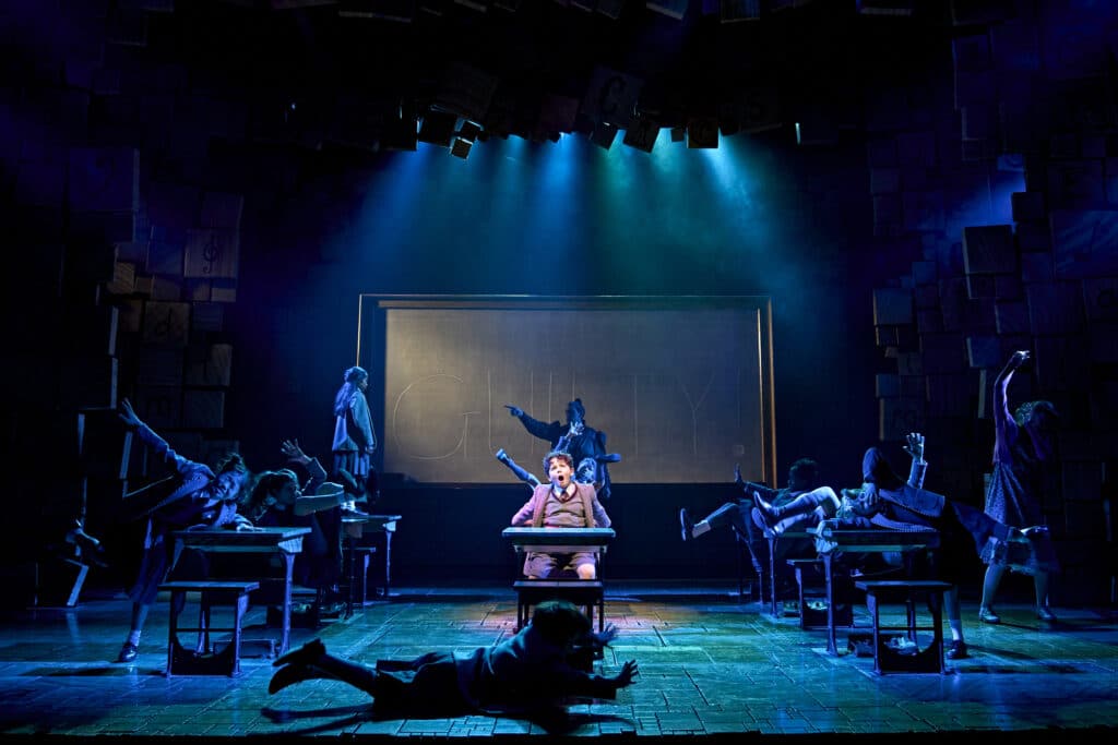 A group of actors during a Matilda performance scene