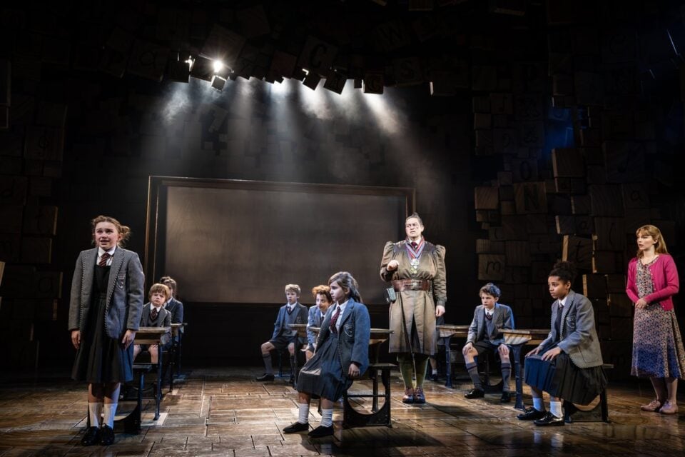 Pupils seated in the classroom as a performer stands before them
