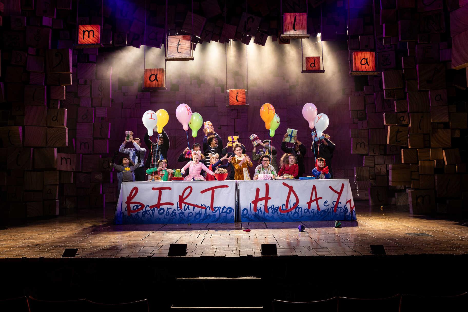 A Matilda The Musical stage scene with performers and set