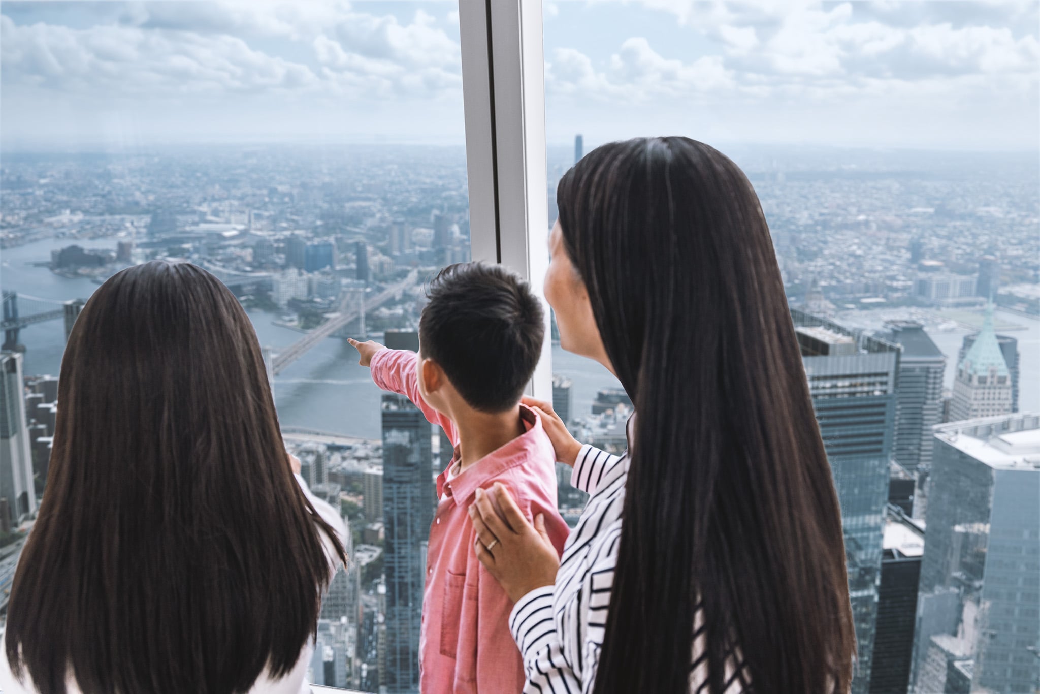 Family viewing the city from One World Observatory