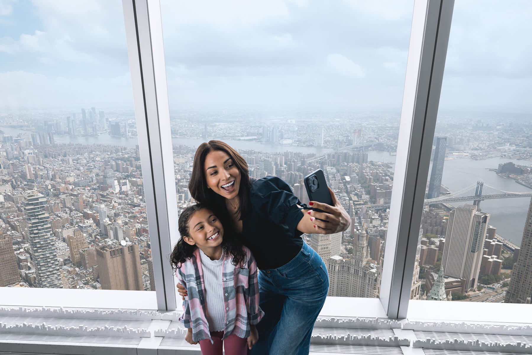 Family looking out over New York at One World Observatory