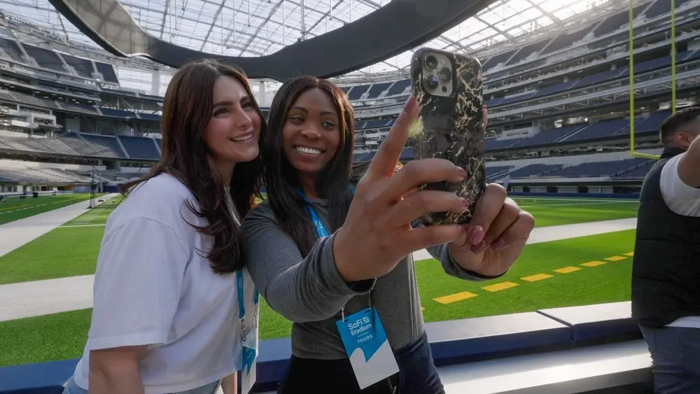 Visitors taking a photo on the SoFi Stadium field