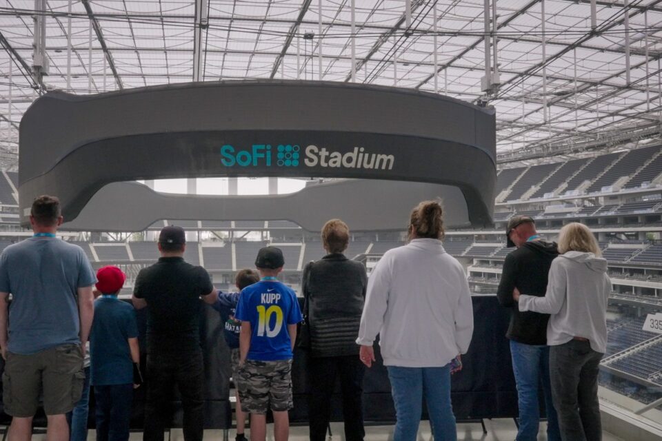 Visitors viewing the SoFi Stadium scoreboard from an elevated tour platform